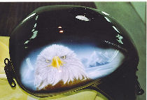   Tank of motor bike: portrait of eagle on bottom of snow-covered mountains.
