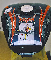 Tank of motor bike painted: Jocker.